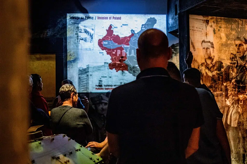 Tourists watching an educational presentation at Schindler's Factory tour
