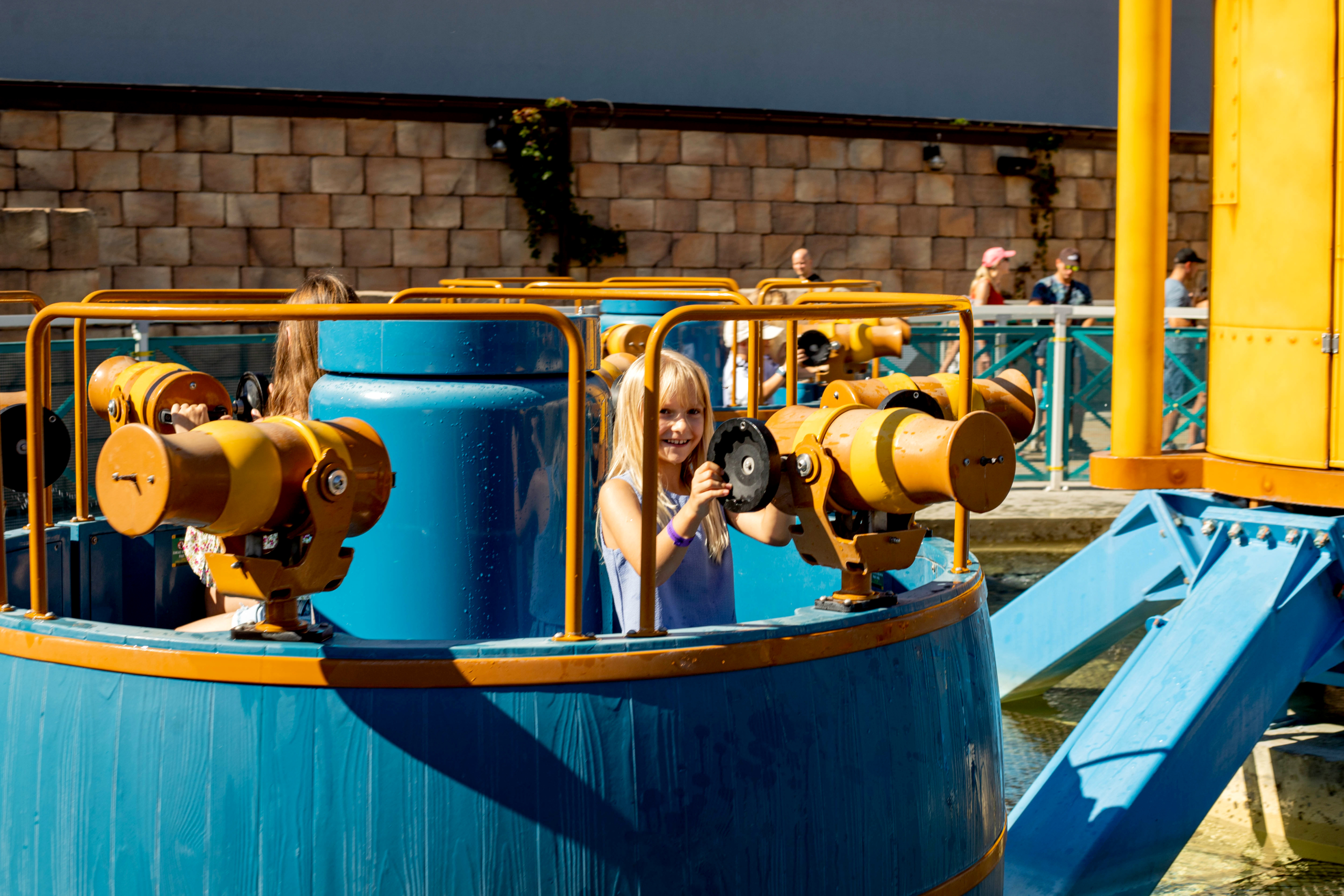 Kids water ride fun at the amusement park Child enjoying a water ride with water cannons at Energylandia amusement park.